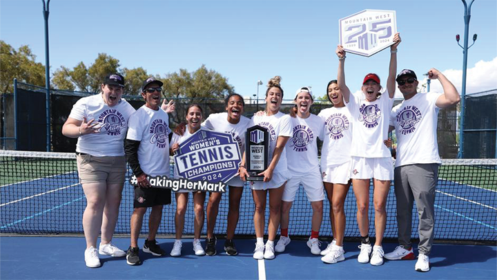 SDSU women's tennis team pose for a photo with their trophy