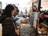 An SDSU art student presents color-changing paint pieces to a group of attendees. (Bryana Quintana/SDSU)