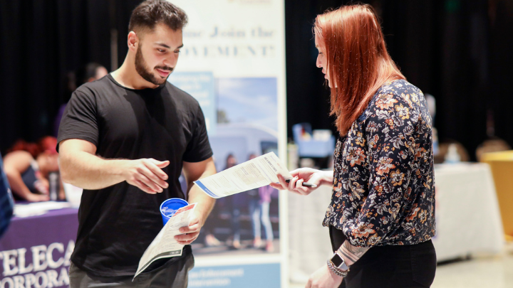 person talking to a recruiter at an event