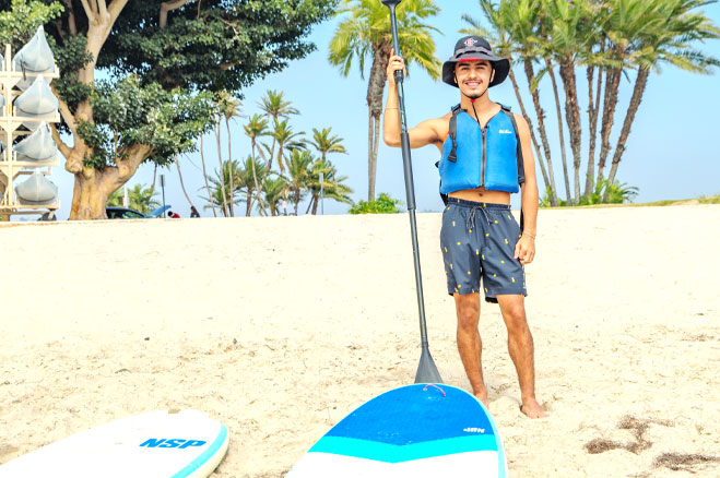 Student with a stand up paddle board at the MBAC.