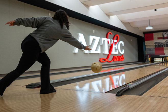 A student bowling at Aztec Lanes.