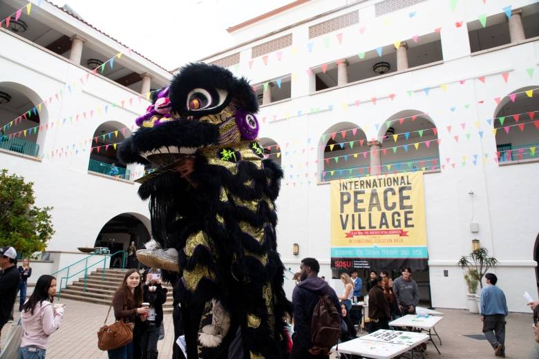 A Lion Dance dragon mingles with the crowd at this year's SDSU International Peace Village
