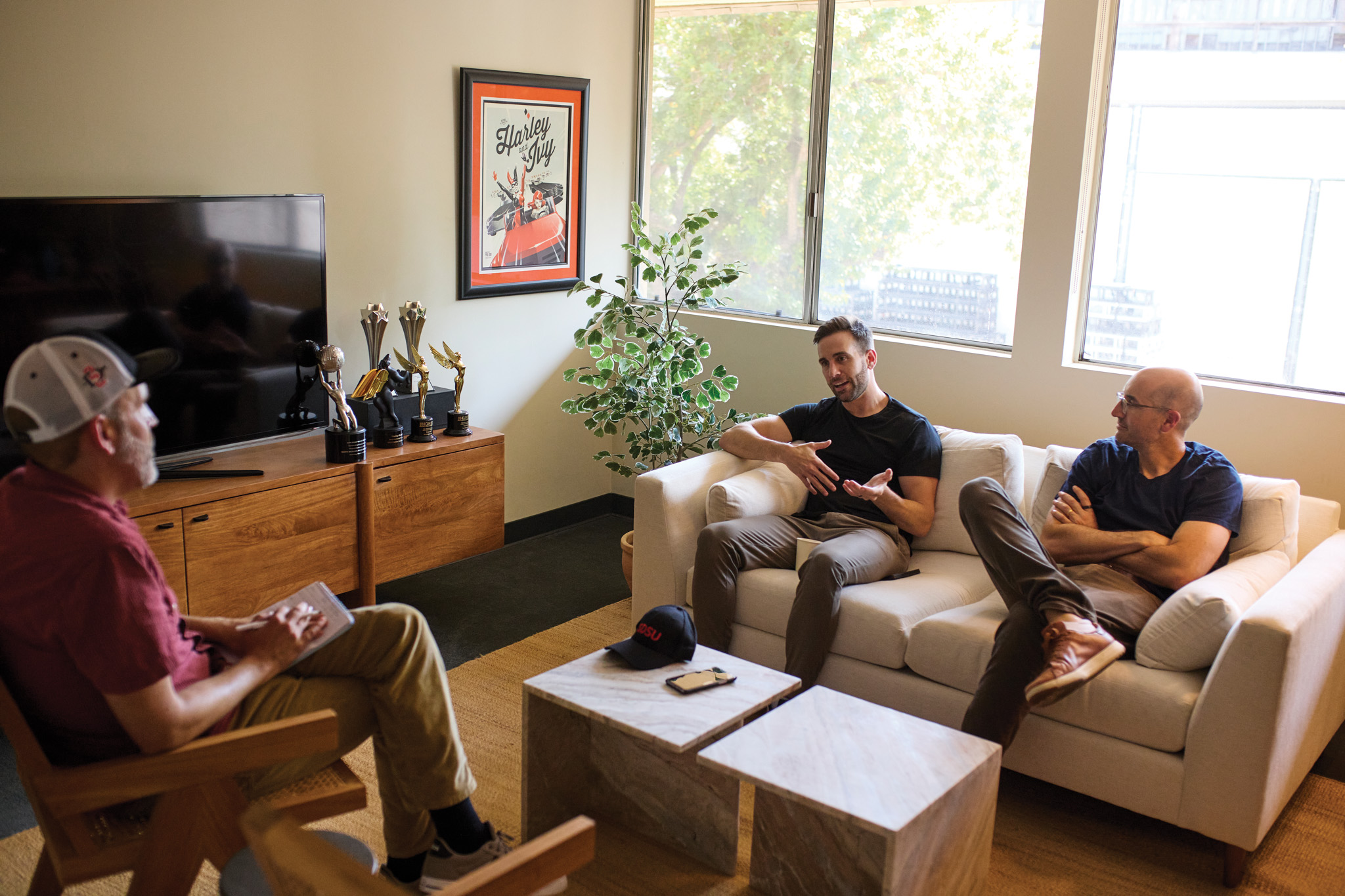 3 people sitting on couches