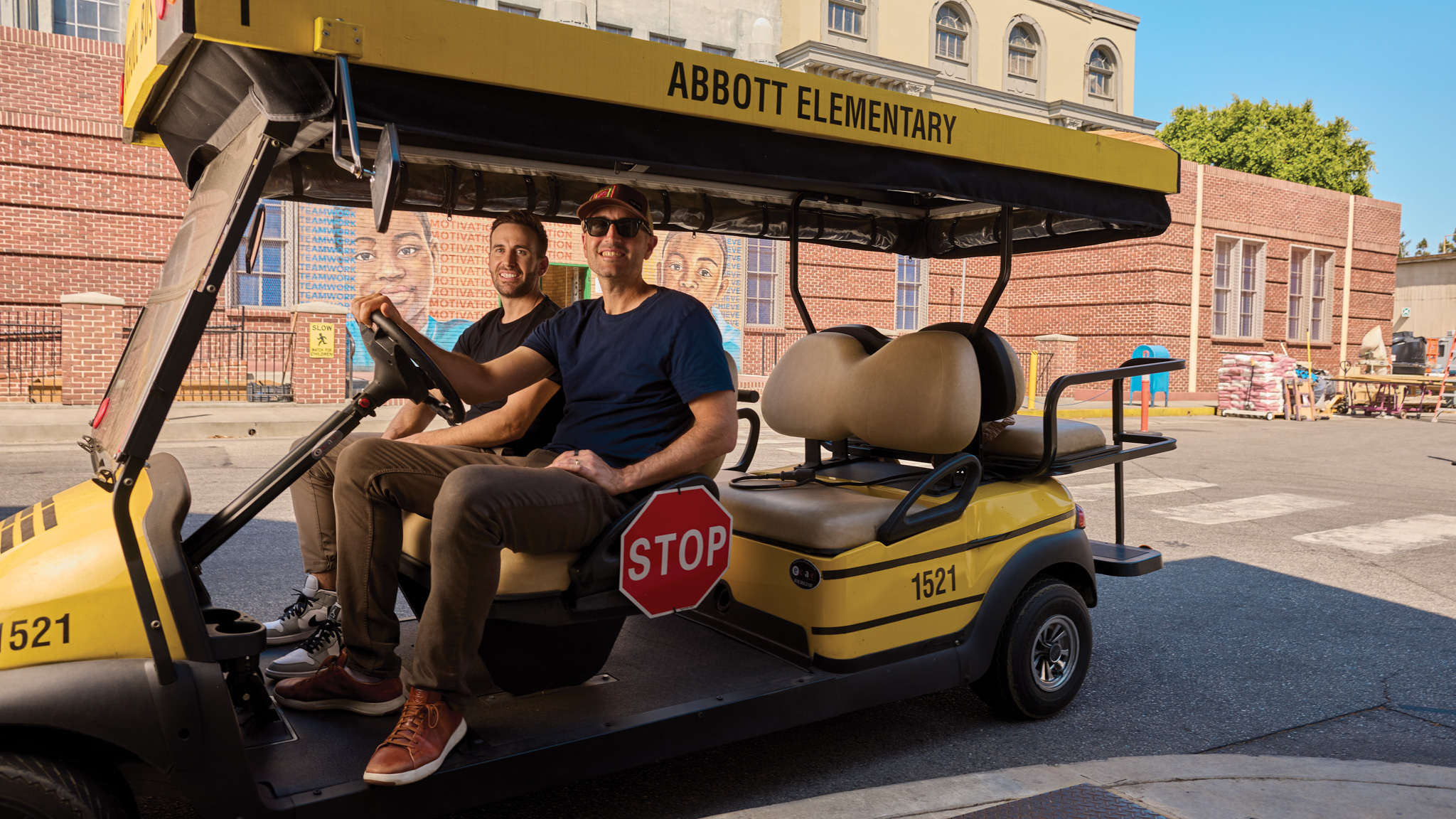 2 men in a golf cart