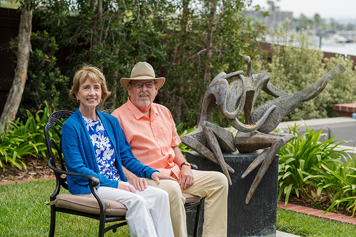 Man and Woman sitting next to each other on a bench