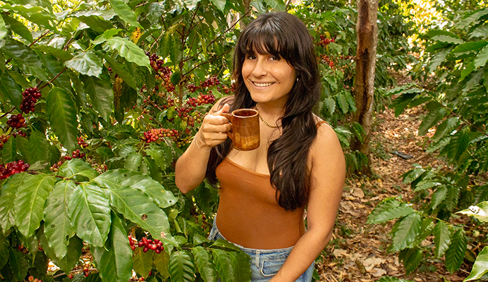 Girl holding coffee and smiling 