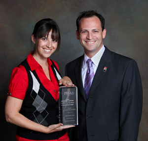 SDSU Media Relations Manager Gina Jacobs, left, and Greg Block, director of new media and media relations, pose with the award at the ceremony.