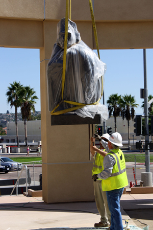 Montezuma statue being brought down by crane