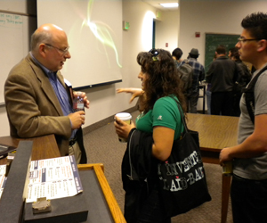 Sageman speaks with an SDSU student following the lecture.