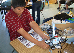 A Morse High School student working on a robotics project.