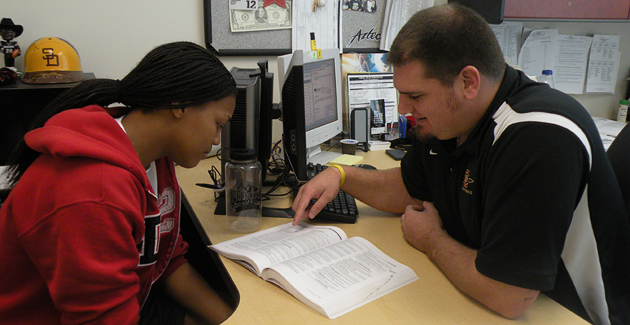 Women's basketball student-athlete Kalena Tutt (left) speaks with academic advisor Willie Judd.