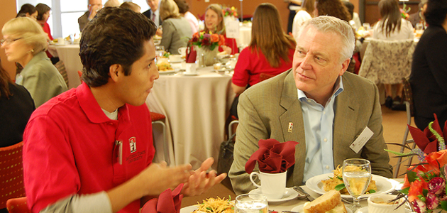 A student scholarship recipient speaks with a donor.