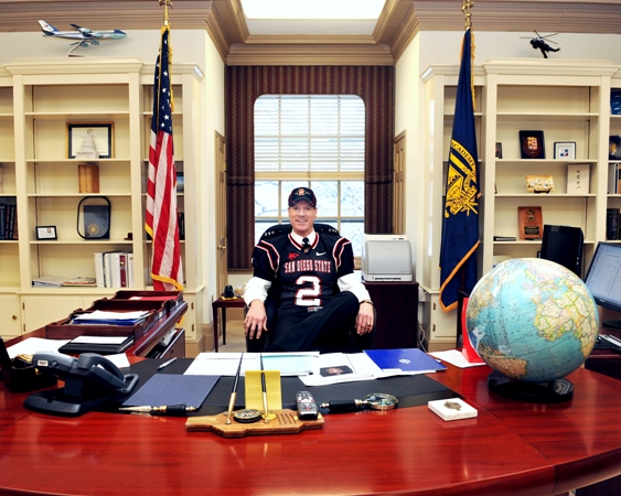 The Naval Academy Superintendent paid off his bet with SDSU President Weber by wearing Aztec colors on campus for a day.