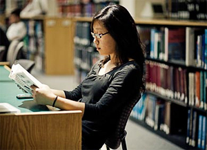 A student studies in the SDSU Library.
