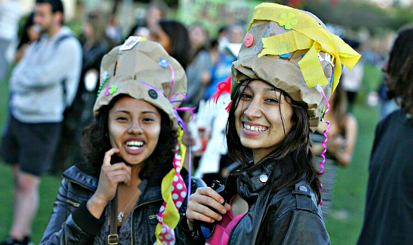 Two students enjoy GreenFest 2011 by making hats out of paper bags.