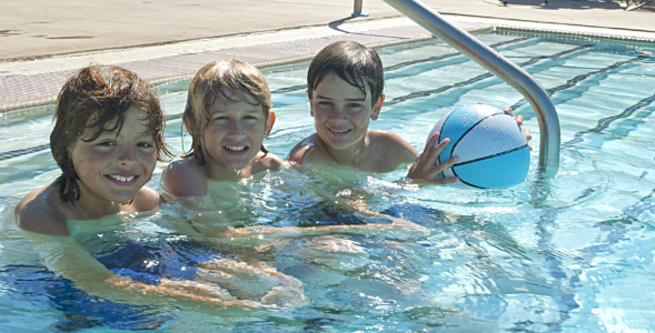 Three boys enjoy some time in the Aztec Aquaplex recreation pool.