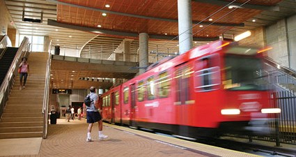 A trolley arrives at the SDSU underground station.
