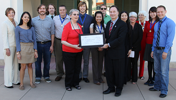Robin Luby, president of the local Achievement Rewards for Colleges Scientists chapter, presents SDSU a ceremonial check in support of science and engineering scholarships for students.