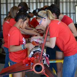 Alexis Mendoza and Vanessa Bundy work on the rocket at an SDSU Rocket Project launch. 