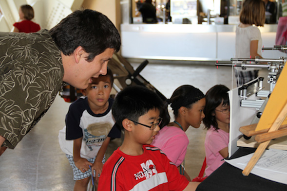 An SDSU CRMSE student works with local children at the 2013 Science Expo.