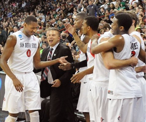 The team celebrates at the end of the 63-44 win over North Dakota State University (photo by Ernie Anderson)