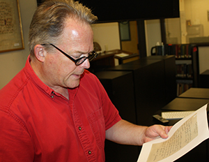 Special Collections and University Archives Director Rob Ray examines a D-Day letter from the SDSU Library's World War II Servicemen's Correspondence Collection.