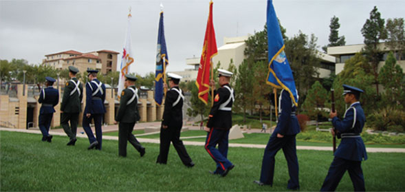 SDSU ROTC members carrying flags.