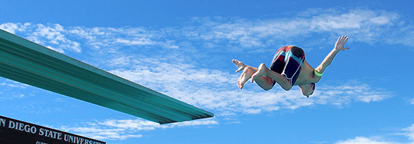 An Aztec Recreation member jumping off the high dive.