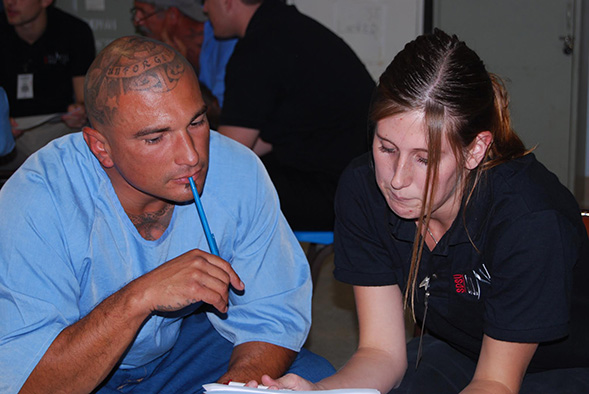 An SDSU student works with an inmate at the Richard J. Donovan Correctional Facility. (Credit: Paul Sutton)
