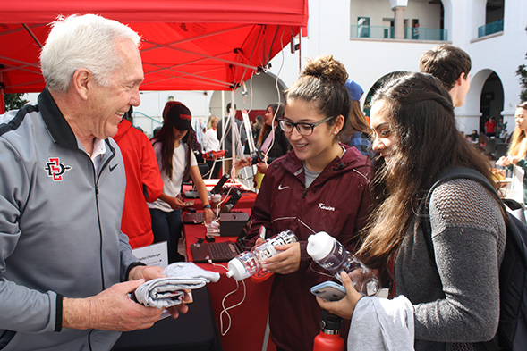 SDSU head football coach Rocky Long interacts with student donors.