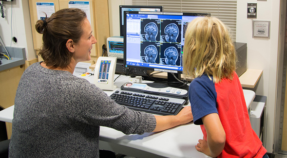 Sarah Reynolds, a research coordinator on Dr. Inna Fishmans team, and a participant reviewed the childs brain images after the scan.