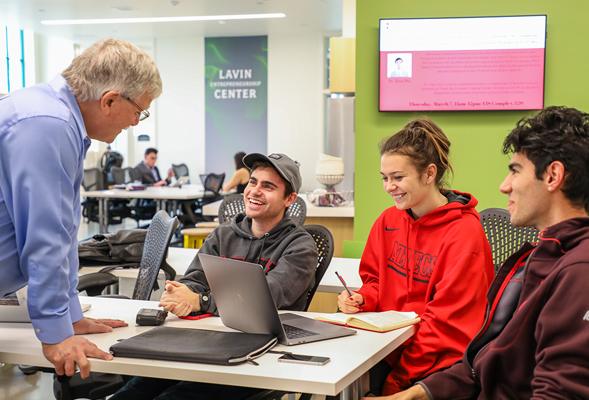 Alex DeNoble, director of the Lavin Entrepreneurship Center, in class with Chad Vardas, left, Paige Doherty and Michael Kosoff.