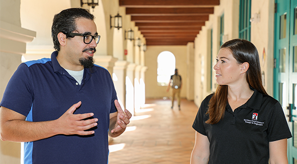 Engineering major Tyler Perez, who received the 2019 CSU Trustees Award for Outstanding Achievement, speaks with his mentor Brittany Field. Photo: Scott Hargrove for SDSU