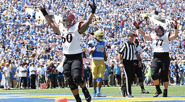 Keith Ismael (#60) celebrates an SDSU touchdown versus UCLA at the Rose Bowl.