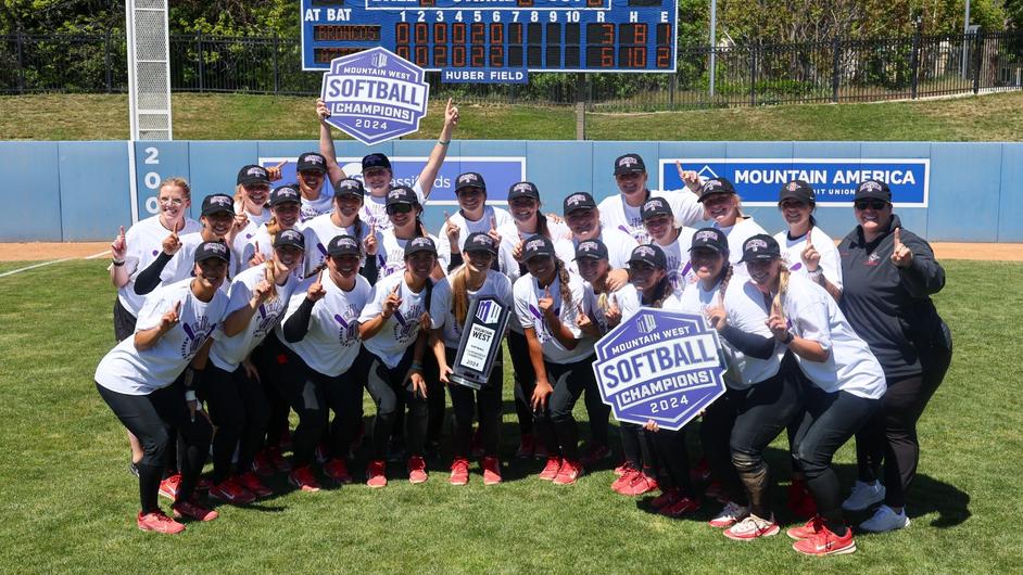 The SDSU women's softball team pose with their Mountain West conference title following their win.