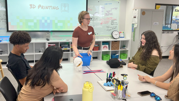 Officers from Student Affairs and Campus Diversity learn about 3D printing with Mariah Finley-Gardner