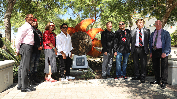 In the photo: Chris Manning, VP for Student Affairs and Campus Diversity; Jacob Alvarado Waipuk, tribal liaison, President Adela de la Torre; Johnny Bear Contreras, sculptor; James Frazee, VP for Information Technology and Chief Information Officer; Chris Medellin, Native Resource Center director; William Tong, Interim Provost; Stuart Voytilla, SDSU Story Lab faculty lead. 