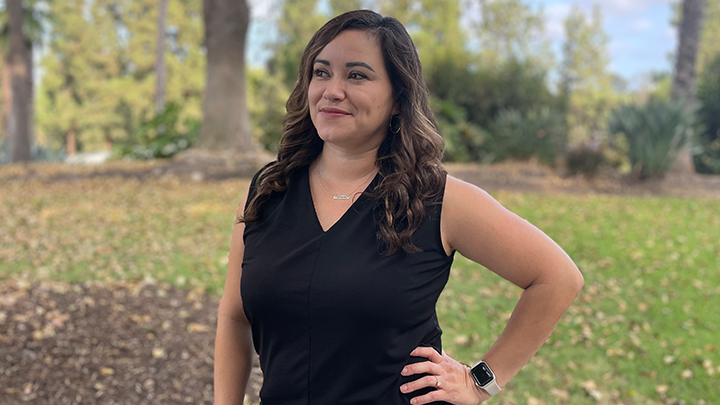 Marissa Vasquez is photographed under trees in a park-like setting at SDSU.