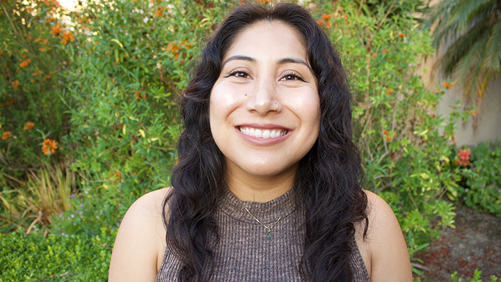 Sophia Rodriguez smiles into the camera photographed on campus