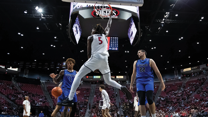 SDSU's freshman forward Pharaoh Compton scores on a dunk against CSU San Marcos defenders.