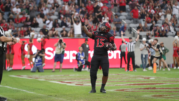 SDSU running back Marquez Cooper celebrates a touchdown in the end zone.