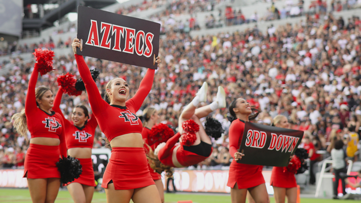 SDSU's spirit squad leads Snapdragon Stadium fans in a cheer.