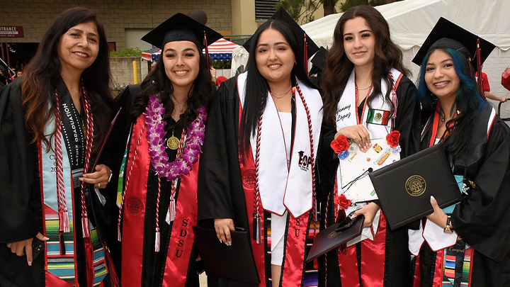 A group of graduates wearing San Diego State University caps and gowns.