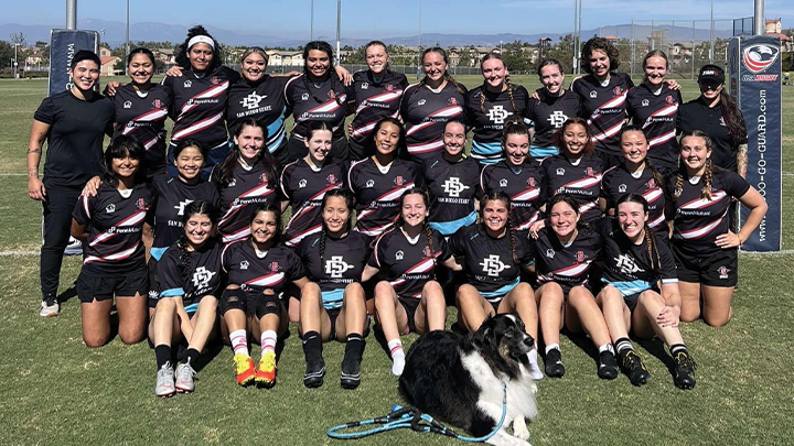 The SDSU women's rugby team pose for a photo on the field at the campus.