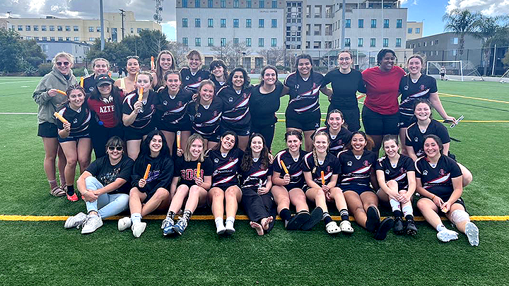 The SDSU women's rugby team pose for a photo on the field at the campus.