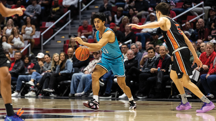 SDSU player shoots over an Occidental College opponent during their game.