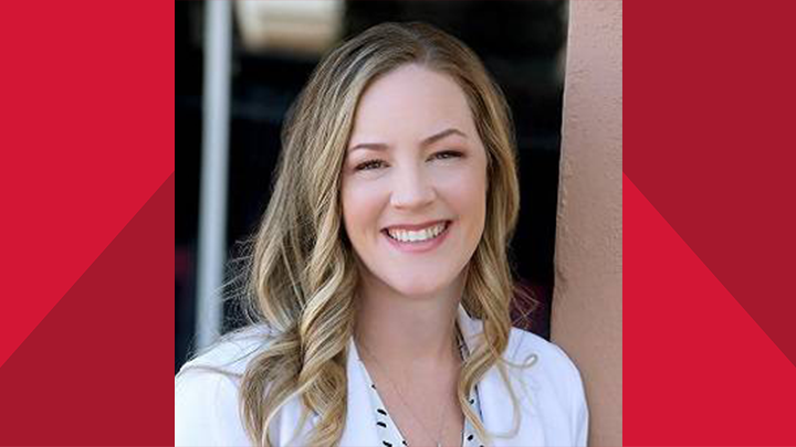 Photo of Shiloh Williams dressed in a white coat smiling into the camera while on the campus of SDSU Imperial Valley.