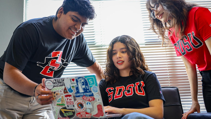 SDSU students gather around a computer