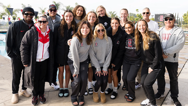 SDSU swim and dive team pose for a photograph at the Aztecs swimming facility