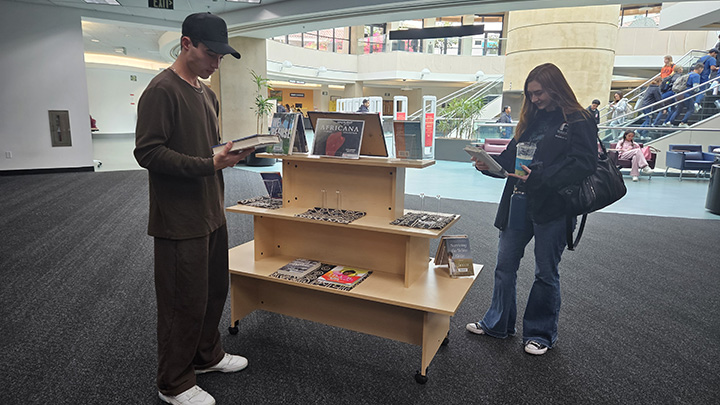 Students reading from a selection of books about Black history.